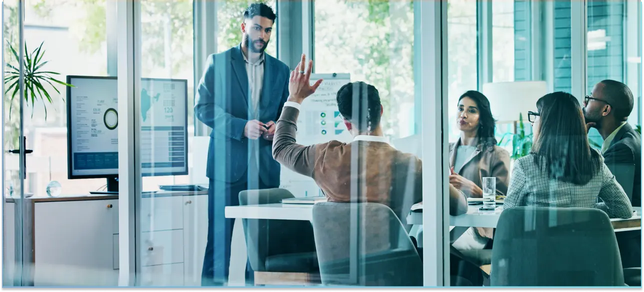 A business meeting in a glass-walled conference room with five people_Wintershall_Dea-Reference-Story